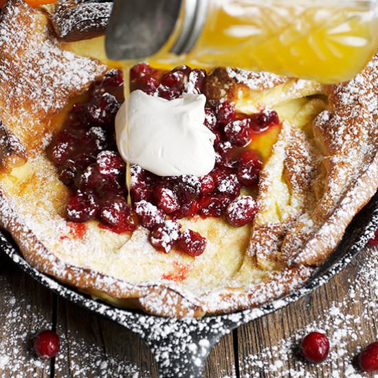 Cranberry Orange Syrup Dutch Baby - Recipe photo by seasonsandsuppers