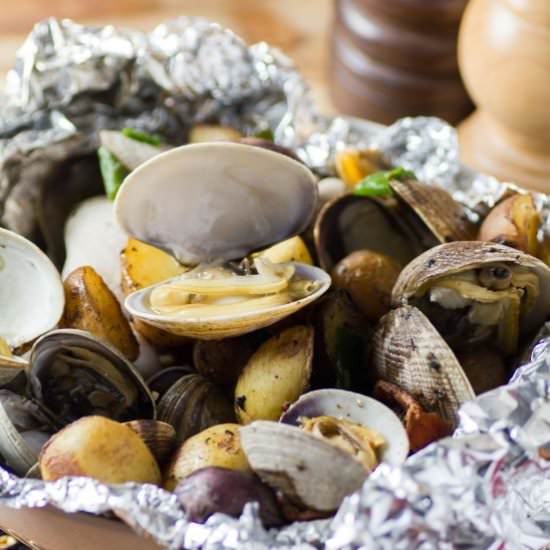 Clam Bacon Little Potato Foil Packs - Recipe photo by noshingwiththenolands