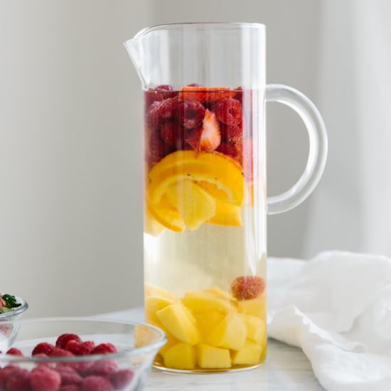 White Sangria with Mango & Berries - Recipe photo by Downshiftology