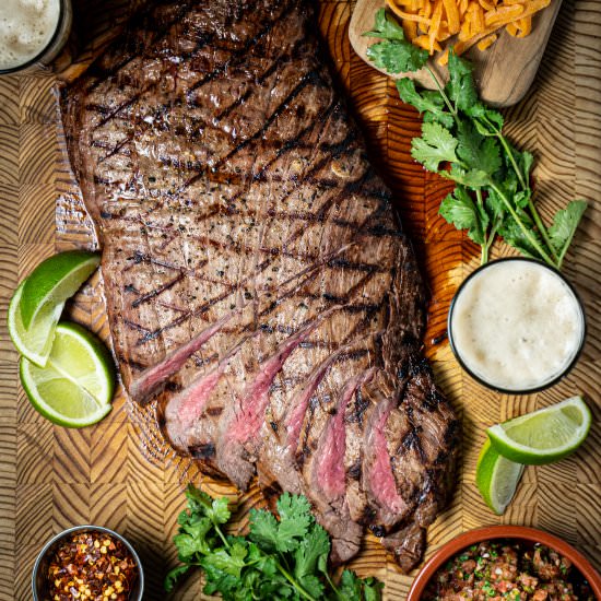 Marinated flank steak on the grill - Recipe photo by photosandfood
