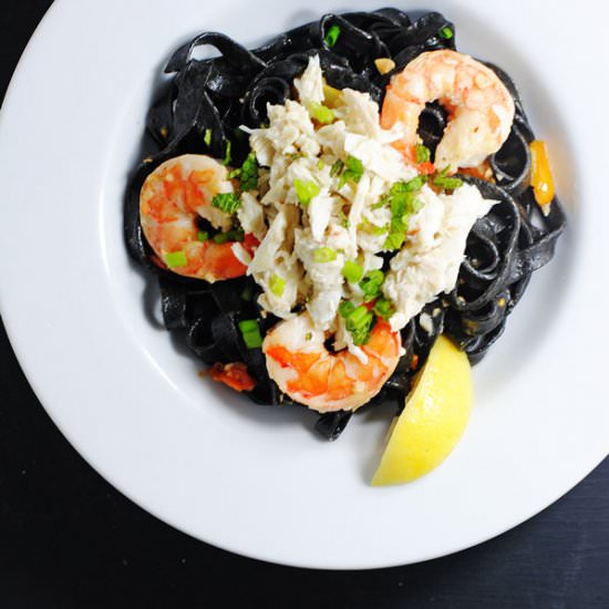 Black pasta with shrimp and crab - Recipe photo by white plate blank slate