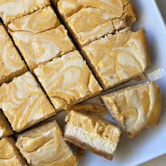 Easy Pumpkin Swirl Cheesecake Bars - Recipe photo by thegranoladiaries