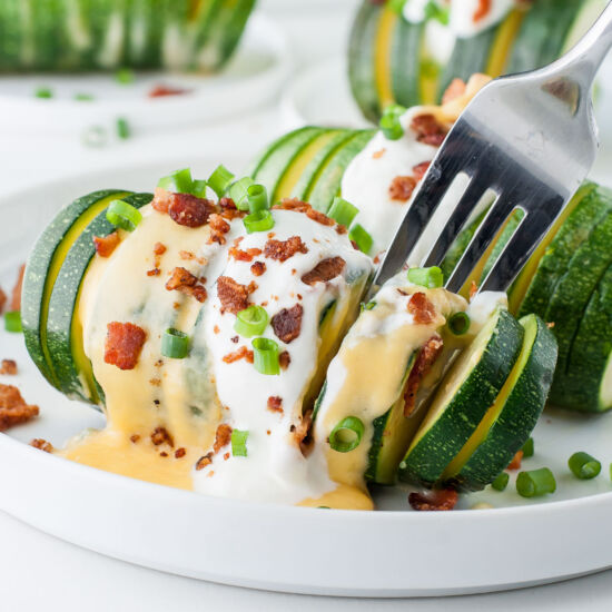 Cheesy Loaded Hasselback Zucchini - Recipe photo by peasandcrayons